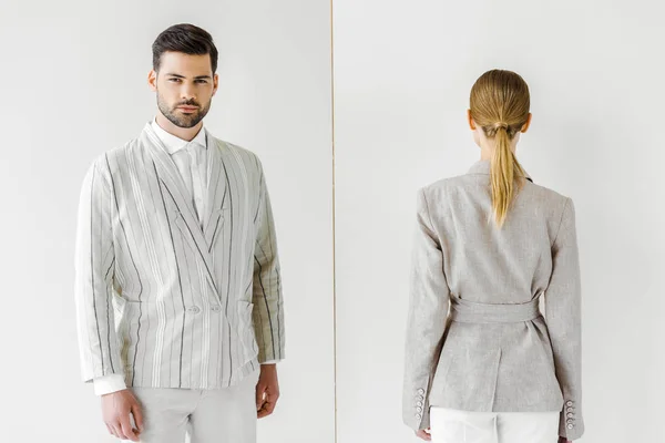 Young male and female models in vintage clothes standing back and front at camera on white — Stock Photo