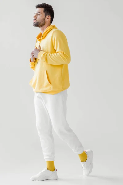 Stylish young man in yellow hoodie on white — Stock Photo