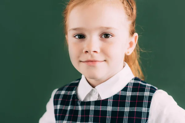Close-up portrait of beautiful little red haired schoolgirl smiling and looking at camera — Stock Photo