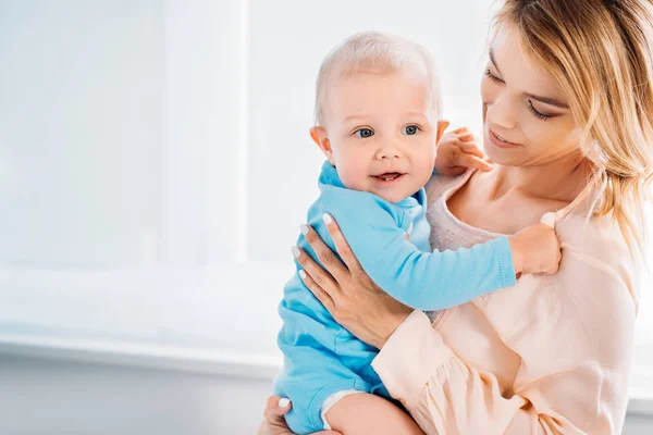 Beautiful young mother embracing her adorable little child — Stock Photo
