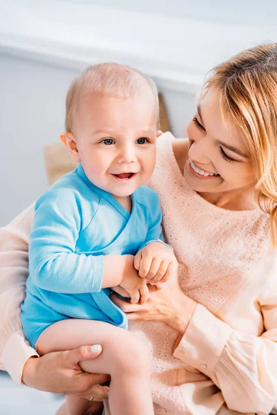 Happy young mother embracing her adorable little child — Stock Photo