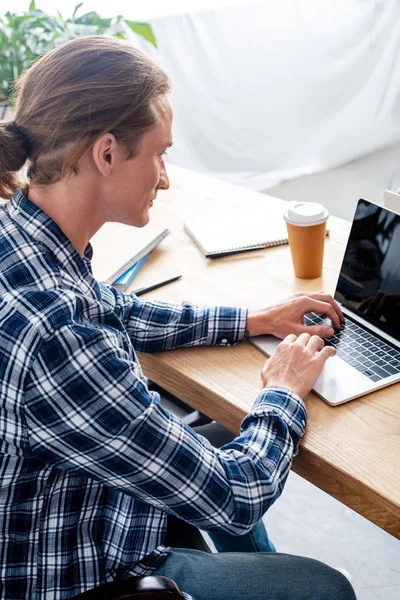High angle view of man using laptop with blank screen at workplace — Stock Photo