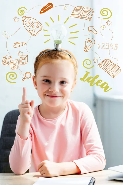 Beautiful schoolgirl pointing up on light bulb on head with idea and icons — Stock Photo