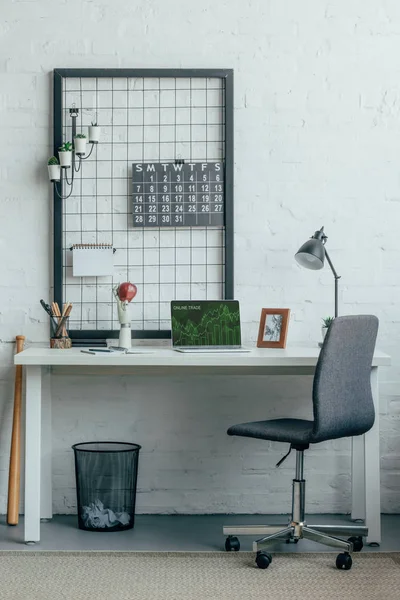 Laptop with loaded online trade page on table in modern office — Stock Photo