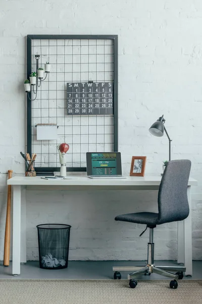 Ordinateur portable avec page de paris sportifs chargée sur la table dans un bureau moderne — Photo de stock