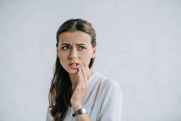 Attractive young woman suffering from toothache and looking away — Stock Photo