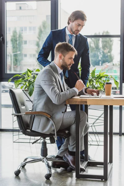 Focused young businessmen working together in office — Stock Photo