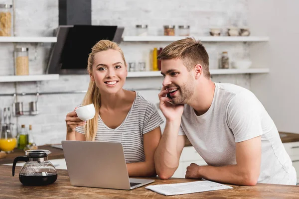 Smiling couple working together with laptop in morning — Stock Photo
