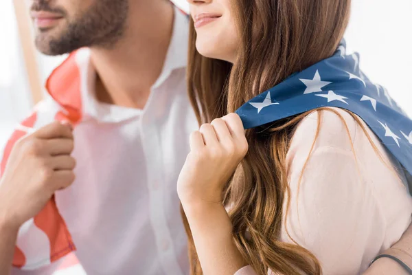 Partial view of couple covered with american flag at home — Stock Photo