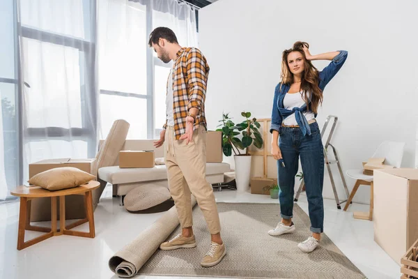 Young couple at new house with cardboard boxes, moving home concept — Stock Photo