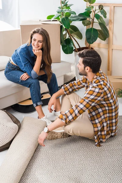 Young couple at new house with cardboard boxes, moving home concept — Stock Photo