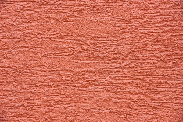 Vista de cerca del fondo texturizado de la pared de hormigón rojo - foto de stock
