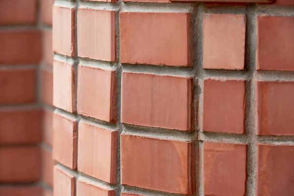 Close-up view of red brick wall background, selective focus — Stock Photo