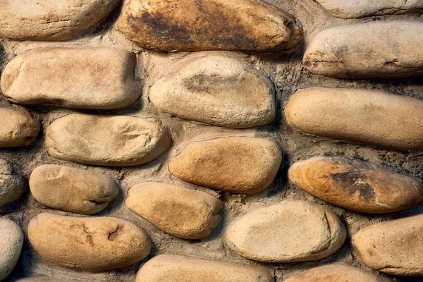 Vista de cerca de la pared de piedra en bruto fondo texturizado - foto de stock