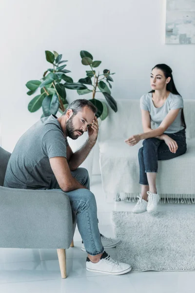 High angle view of frustrated partners sitting on armchair and couch, relationship difficulties concept — Stock Photo