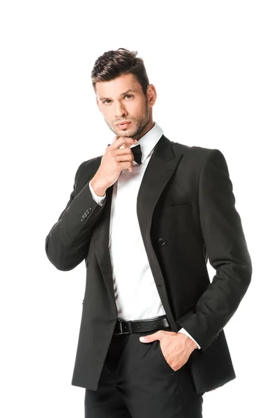 Thoughtful groom in black suit looking at camera isolated on white — Stock Photo