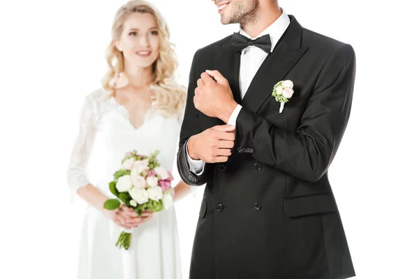 Cropped shot of beautiful young bride and groom isolated on white — Stock Photo