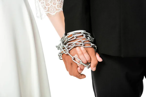 Cropped shot of bride and groom holding hands tied in chain isolated on white — Stock Photo