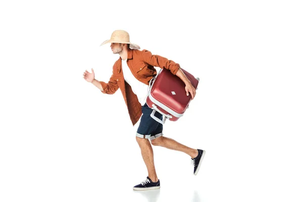 Side view of tourist in straw hat running with travel bag isolated on white — Stock Photo