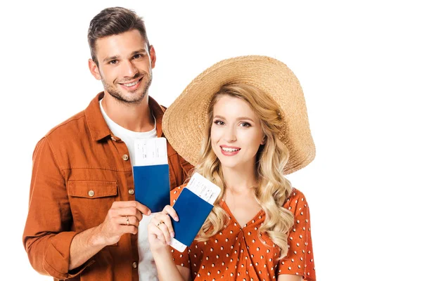 Portrait of smiling couple showing passports and tickets in hands isolated on white — Stock Photo