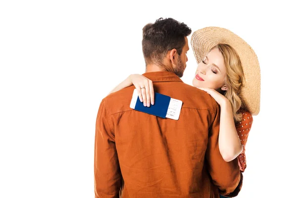 Smiling woman with passport and ticket hugging boyfriend isolated on white — Stock Photo