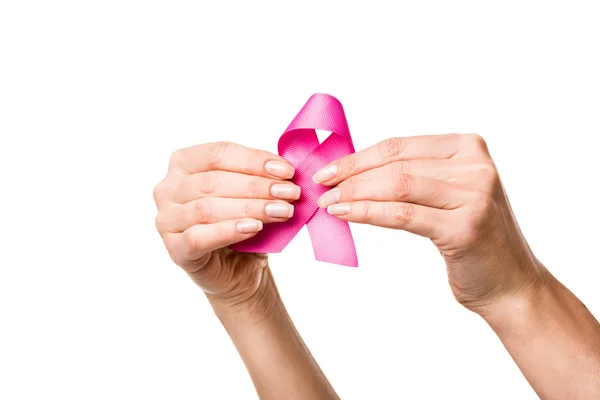 Close-up partial view of woman holding pink ribbon isolated on white, breast cancer awareness concept — Stock Photo