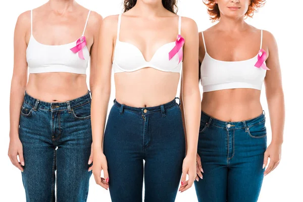 Cropped shot of women in bras with breast cancer awareness ribbons standing together isolated on white — Stock Photo