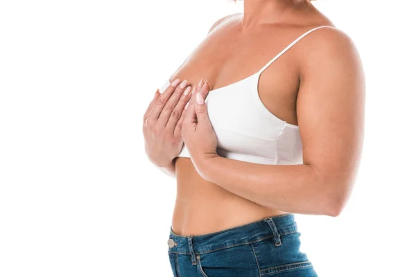 Tiro recortado de mujer de mediana edad en sujetador tocando pecho aislado en blanco - foto de stock