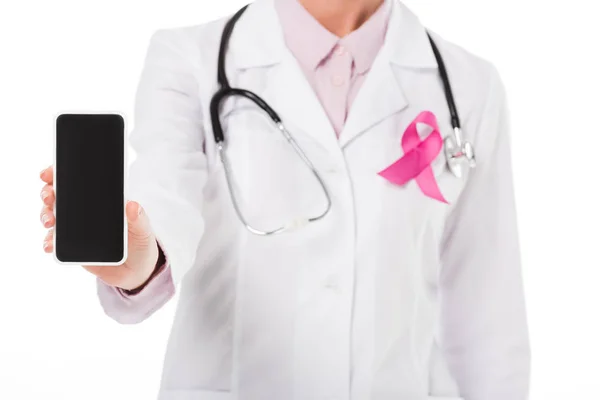 Cropped shot of doctor with pink ribbon holding smartphone with blank screen isolated on white, breast cancer awareness concept — Stock Photo