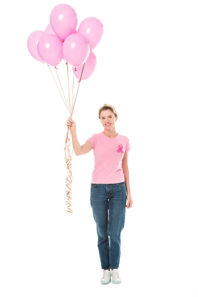 Happy woman holding pink balloons and smiling at camera isolated on white, breast cancer concept — Stock Photo