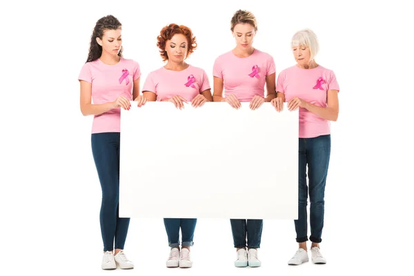 Mulheres em camisetas rosa com fitas de consciência de câncer de mama segurando banner em branco isolado em branco — Fotografia de Stock