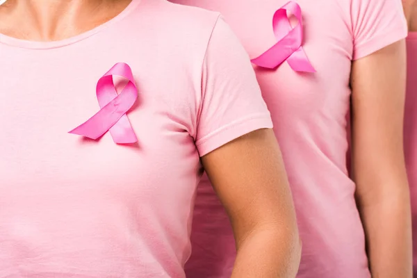 Cropped shot of women in pink t-shirts with breast cancer awareness ribbons — Stock Photo