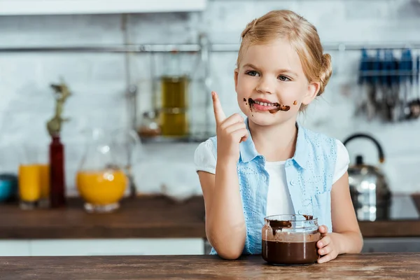 Criança feliz bonito comer chocolate doce propagação — Fotografia de Stock