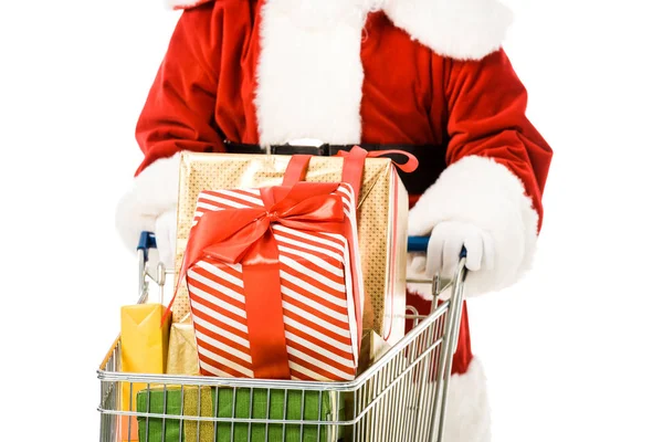 Cropped shot of santa claus driving shopping cart full of gift boxes isolated on white — Stock Photo