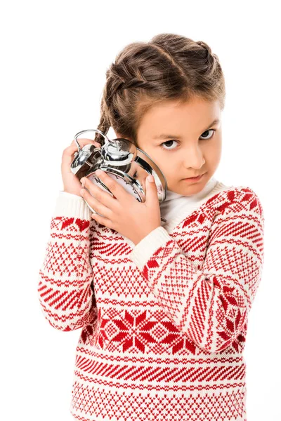 Adorable little child listening alarm clock and looking at camera isolated on white — Stock Photo