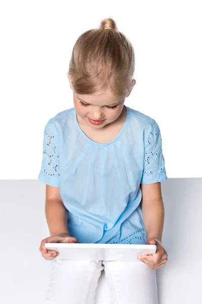 Happy child using digital tablet isolated on white — Stock Photo