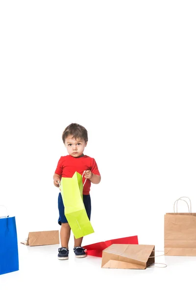 Niño sosteniendo bolsa de compras verde aislado en blanco  . - foto de stock