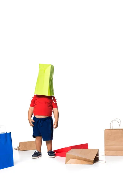 Kid playing with green shopping bag isolated on white . — Stock Photo