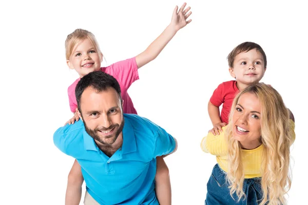 Happy parents piggybacking kids isolated on white — Stock Photo
