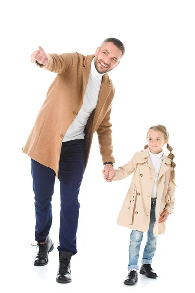 Handsome father showing something to stylish adorable daughter in autumn outfit, isolated on white — Stock Photo