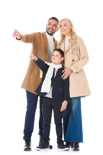 Family and son in autumn beige coats showing something isolated on white — Stock Photo