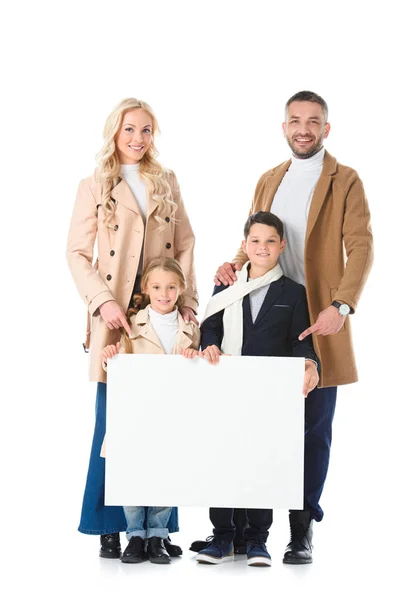 Parents and kids in beige coats holding blank placard, isolated on white — Stock Photo