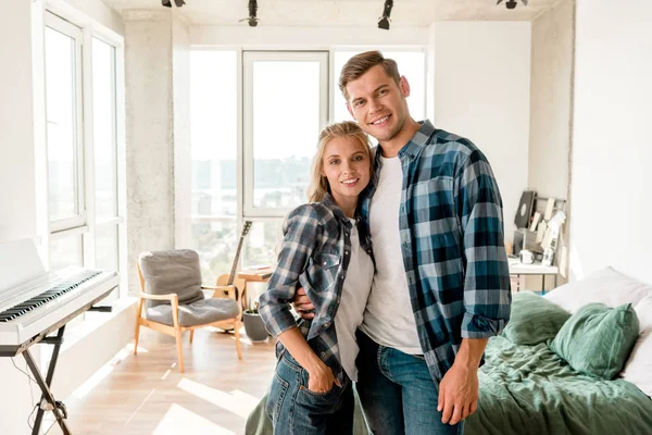 Portrait of happy loving couple hugging at home — Stock Photo