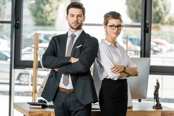 Portrait of confident business people in formal wear with arms crossed in office — Stock Photo