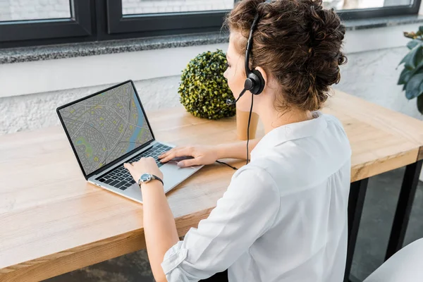 Young female call center operator with headset at workplace in office — Stock Photo