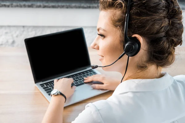 Young female call center operator with headset at workplace in office — Stock Photo