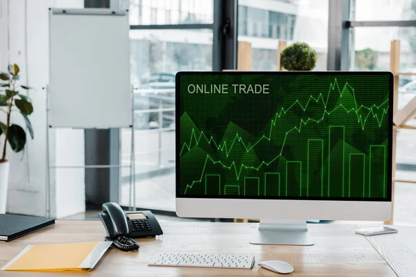 Close up view of workplace with computer screen with online trade lettering in office — Stock Photo