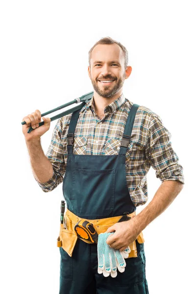 Smiling plumber with tool belt holding monkey wrench and looking at camera isolated on white — Stock Photo