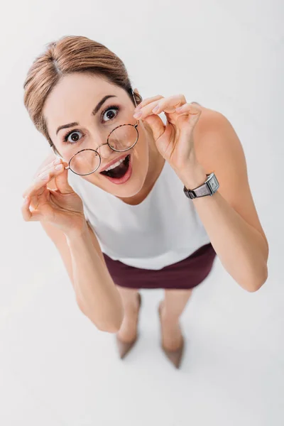 Top view of surprised stylish businesswoman looking at camera on white — Stock Photo