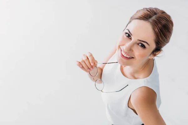 Top view of smiling stylish businesswoman looking at camera on white — Stock Photo